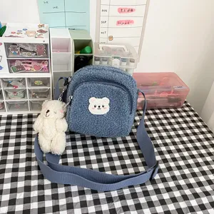 Cute fuzzy lamb wool crossbody bag with bear pendant, soft plush shoulder bag for women.