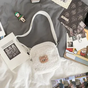 White sherpa plush crossbody bag with cute bear embroidery, soft casual shoulder handbag.