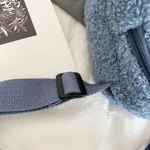 Blue lamb wool crossbody bag detail shot, featuring adjustable strap and zipper closure.