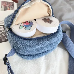 Cute blue lamb wool small crossbody bag for women, fluffy round shoulder bag with sweet bear design inside.