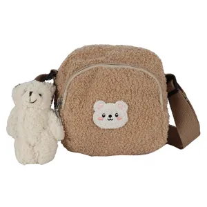 Cute brown fleece crossbody bag with fluffy bear plush pendant and embroidered patch detail.