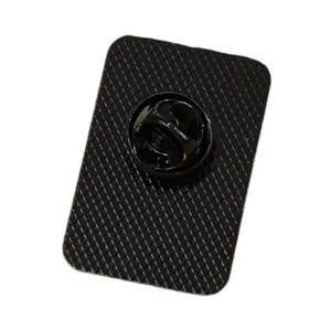 Close-up back view of a metal lapel pin showing secure rubber clutch and textured backing.
