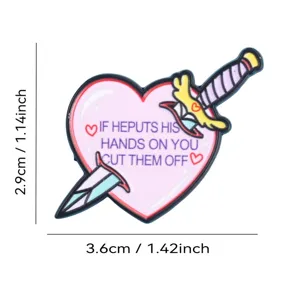 Pink heart dagger enamel pin badge, cute and edgy clothing accessory, detailed shot.