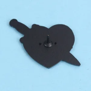 Detailed close-up showing the secure back pin structure of the black heart dagger badge.