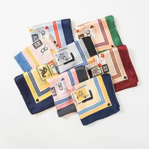 Close-up detail of assorted colorful silk square scarves featuring vintage playing card prints.