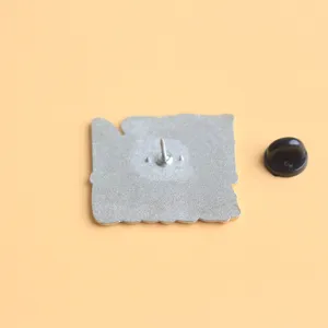 Detailed view of a metal horror movie style enamel pin back with secure rubber clutch.