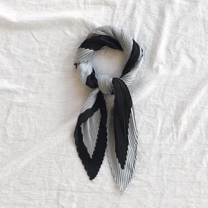 Detailed view of the black and grey pleated silk scarf, elegant neckerchief for women.