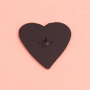 Black heart shaped brooch pin back detail shot, metal lapel pin accessory for bags clothes.