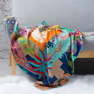 Detailed close-up view of the silk scarf featuring a vibrant multicolored artistic print.