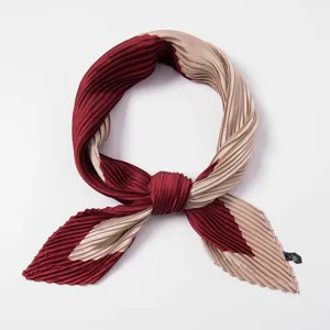 Pleated silk-feel neck scarf detail view, elegant two-tone burgundy and champagne design.