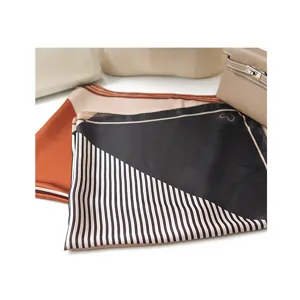 Detail view of the elegant satin square scarf featuring chic stripes and a cute heart pattern.