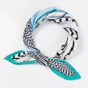 Detailed view of women pleated neck scarf with blue and white geometric pattern elegance.