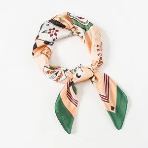 Silk square scarf detail showing vintage playing card pattern and green border design.