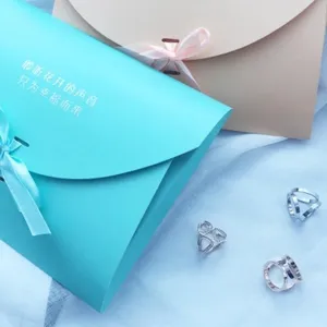 Gift packaging bag set with elegant blue box and delicate rings for wedding and holiday gifting.