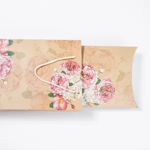 Vintage floral gift box packaging detail showing exquisite pink rose pattern and white cord handle.