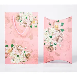 Pink floral paper gift bag and pillow box set for wedding return gifts, elegant present packaging.