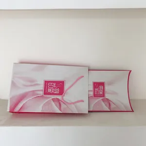 Close-up detail of pink gradient silk scarf gift packaging box and paper bag set elegant style.