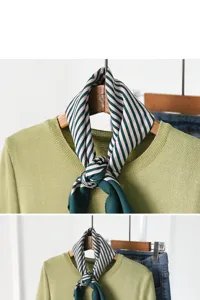 Detailed view of a stylish green striped silk square scarf paired with a matching knit sweater.