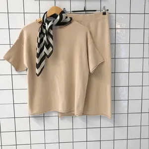 Close-up detail of the knitted top and skirt set with a stylish striped neckerchief.