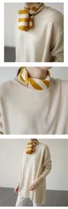 Detail view of yellow-white striped silk scarf neckerchief and casual knit sweater.