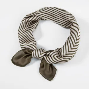 Close-up detail of a vintage striped silk square scarf with elegant knot design for women.