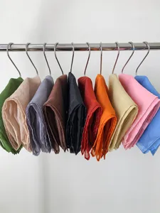 Detailed close-up shot of colorful chiffon solid color silk scarves hanging neatly on clips.