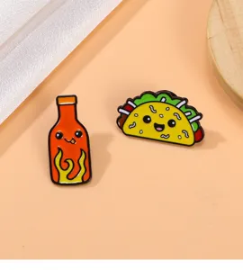 Close-up view of cute hot sauce and taco enamel pins, alloy fashion badges for backpack coat decor.