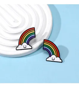 Closeup detail of cute rainbow smiling cloud enamel pins, alloy brooch for bag and clothes.