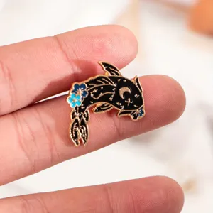 Close up view of the exquisite black and gold koi fish enamel pin, showing fine craft and details.