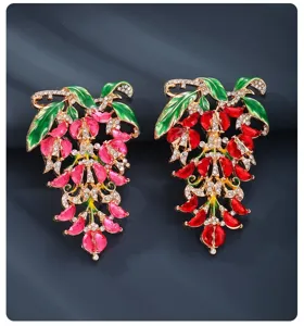 Vintage wisteria flower brooch crystal enamel grape pin elegant clothing accessory detail.