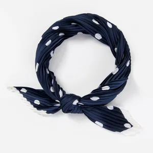 Detailed view of a navy blue polka dot pleated small neck scarf, elegant and versatile.