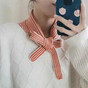 Knit striped scarf detail view, cozy winter neck accessory for women, orange white