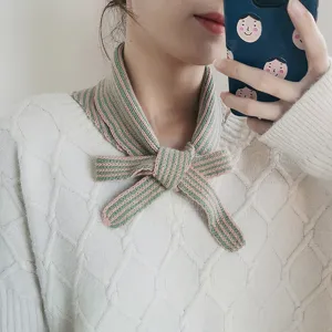 Detailed shot of striped knitted neckerchief, showcasing texture and bow knot styling.