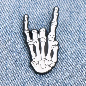 Cool skeleton hand metal enamel pin rock gesture badge jacket accessory for fashion style lovers.