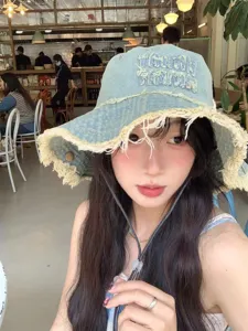 Distressed denim bucket hat for women, trendy frayed edge sun hat, casual outdoor travel cap.