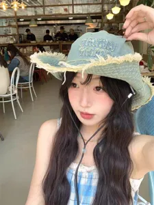 Distressed denim bucket hat for women, vintage frayed edge cowboy sun cap with chin strap.