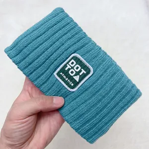 Teal ribbed knit headband with embroidered patch, perfect for daily wear and workouts.