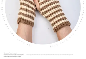 Detail view of brown and white striped knitted fingerless gloves, winter warm handwear.