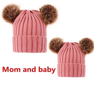 Mom and baby matching winter knit beanie hats with double faux fur pom poms cute pink caps