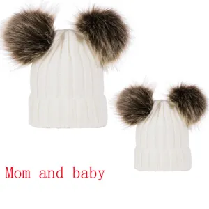 Mom and baby matching white knit beanie hat set with cute fluffy double faux fur pom poms.