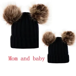 Parent-child knitted beanie hat with double fluffy faux fur pom poms for women and kids.