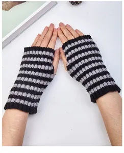 Detail shot of black and white striped fingerless knit gloves, warm and cozy winter wristwear.