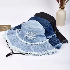 Vintage denim bucket hat with frayed edges and chin strap, casual sun protection hat.