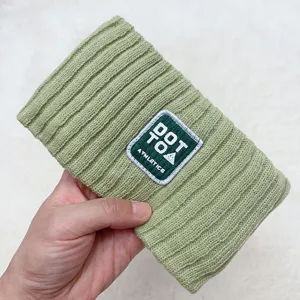 Green knitted headband with letter patch, soft accessory for daily washing and cute outfits.