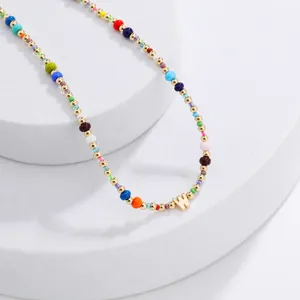 Bohemian colorful seed bead necklace with gold letter W pendant, trendy fashion jewelry for women.