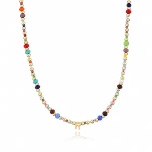 Exquisite bohemian colorful seed bead beaded necklace detail showing gold initial letter R pendant.