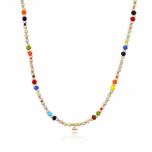 Close-up detail of bohemian colorful seed beads necklace with gold metal Z letter pendant.