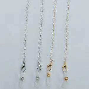 Crystal beaded eyeglass chain detail close-up, mask lanyard connector, shiny metal links.