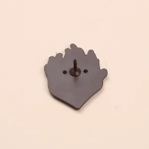 Detailed view of the metal brooch back pin in dark brown color, showing secure pin post.