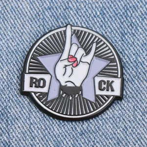 Metal enamel pin badge featuring rock hand gesture and star design for jacket clothing decor.